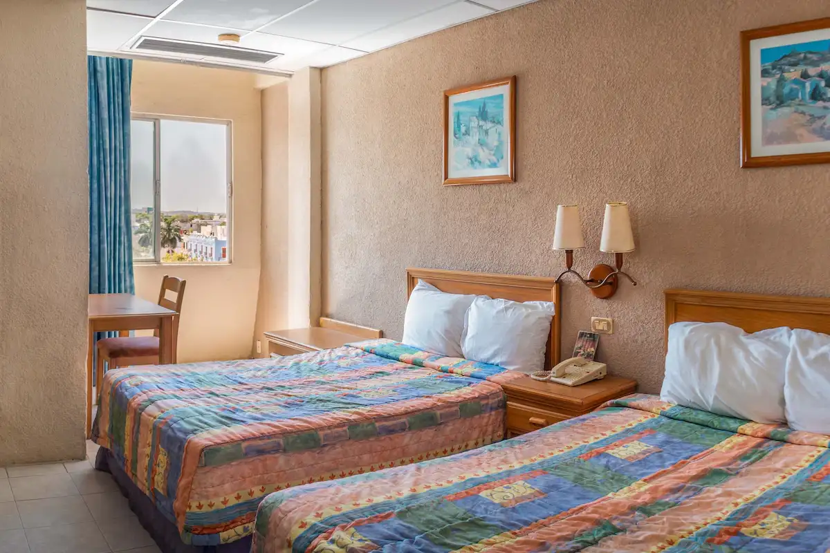 Twin double bed room with window view at Hotel Baluartes